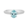 Anillo de oro blanco con diamantes 0,17 quilates y topacio azul